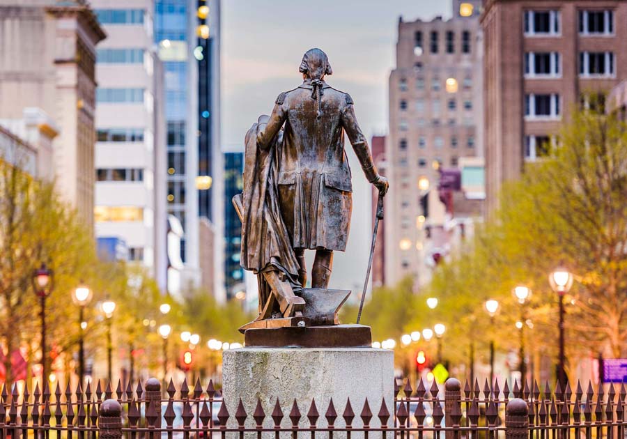 Raleigh downtown statue on light-lined street