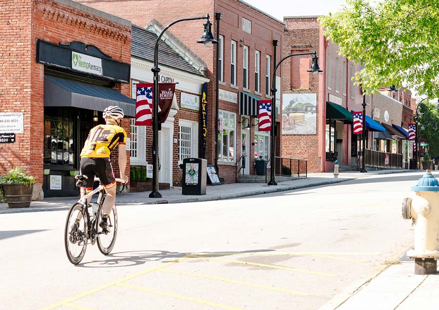 Road cyclist riding downtown Wake Forest, NC
